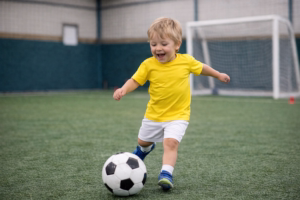 Toddler playing soccer indoors at Soccer Field Academy in Columbus, Ohio