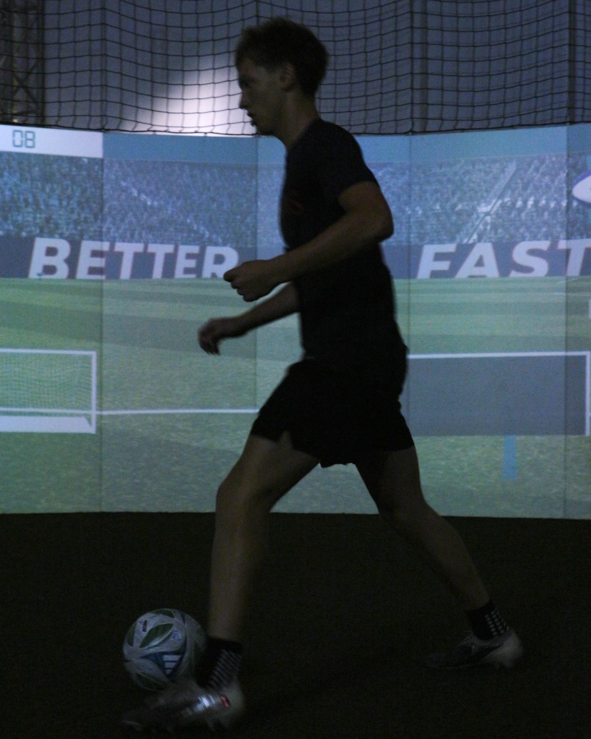 SFA player running a dribbling drill inside the SoccerBot360 arena in Columbus, Ohio