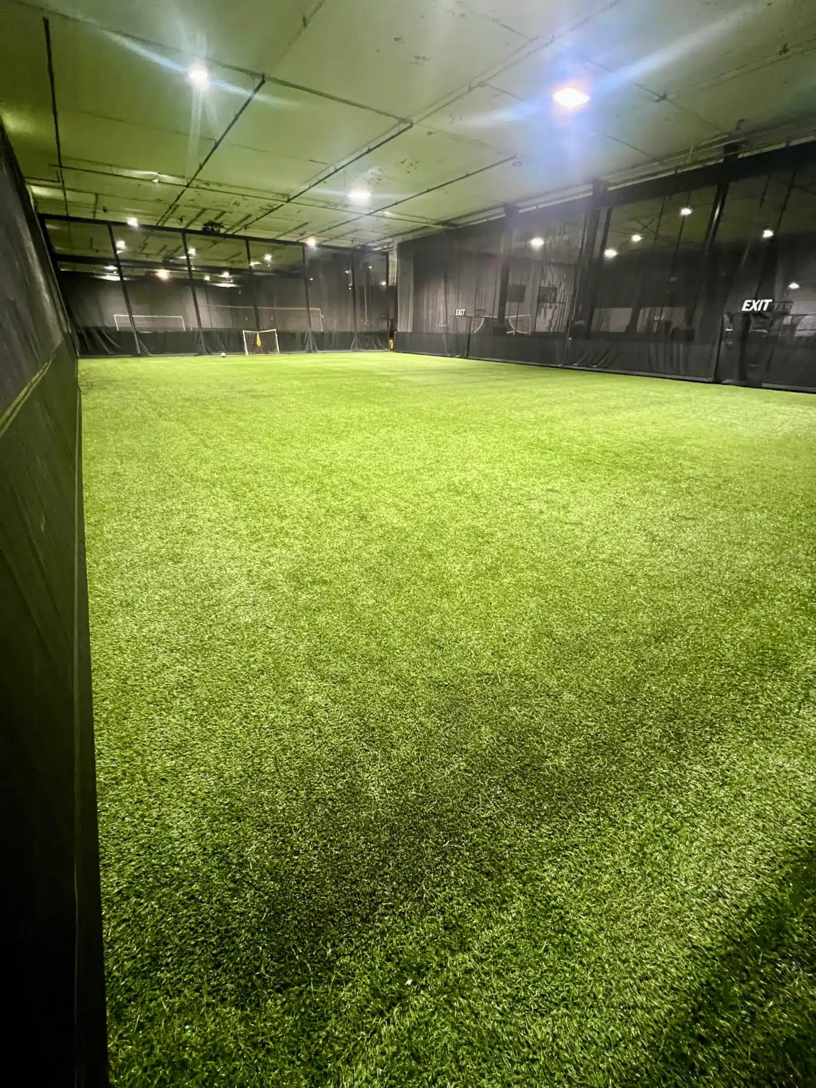 Empty indoor turf field under lights at Soccer Field Academy in Columbus, ready to rent